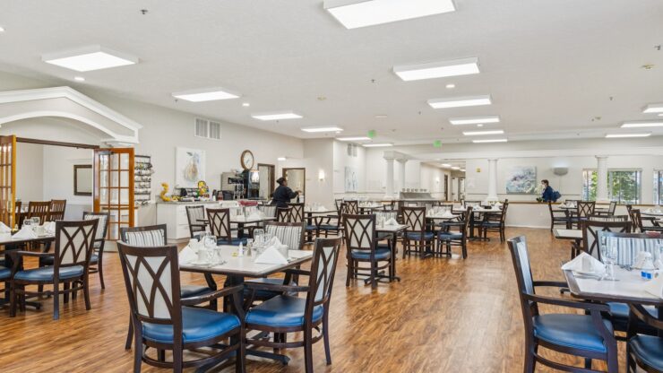 A welcoming dining area filled with light, offering comfortable seating for community gatherings.