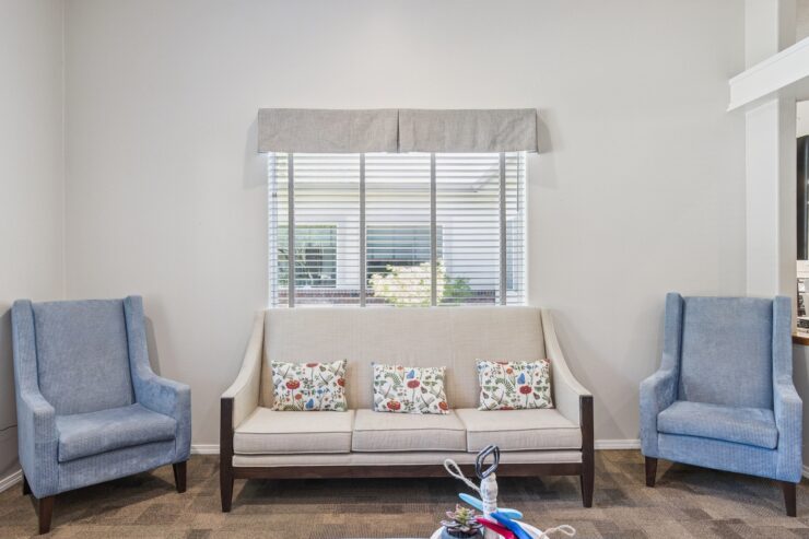 A welcoming lounge area with comfortable seating, inviting natural light, and cheerful decor fosters community and warmth.