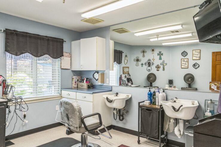 A welcoming salon space with bright lighting, comfortable chairs, and a warm community atmosphere.
