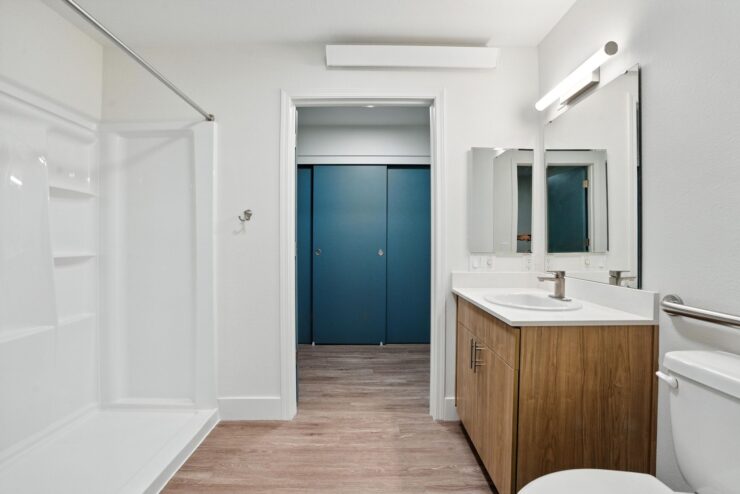 Bright and inviting bathroom featuring modern fixtures, offering comfort and ease for residents.