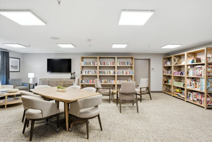 A welcoming community space filled with books, comfortable seating, and a warm atmosphere for gathering.