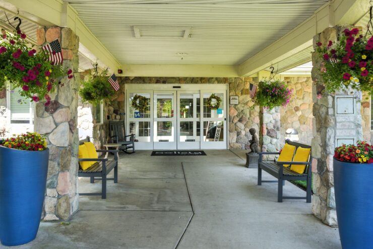 Welcoming entrance with cheerful seating and vibrant greenery, inviting a sense of community and warmth.