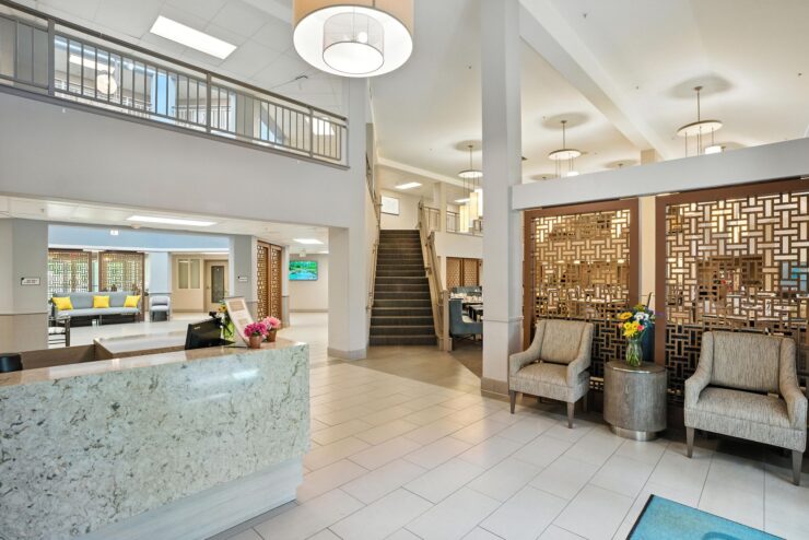 Welcoming lobby with elegant decor, inviting seating, and vibrant flowers, fostering community and warmth.