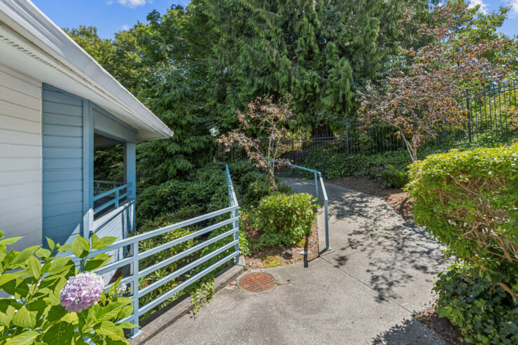 A serene pathway leads through lush greenery, inviting residents to explore and connect with nature.