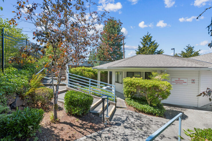 A welcoming entrance surrounded by lush greenery invites residents to enjoy a vibrant community atmosphere.