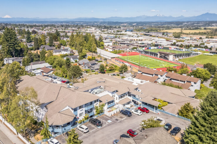 A welcoming community surrounded by greenery, featuring comfortable residences and nearby recreational spaces.