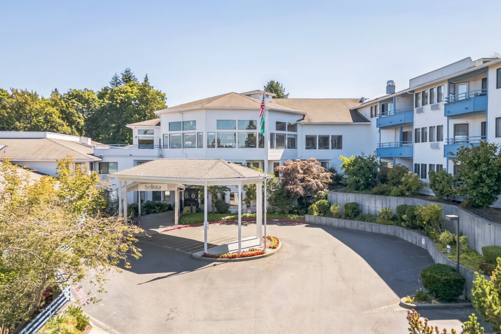 A welcoming entrance surrounded by lush greenery invites residents to a vibrant community.