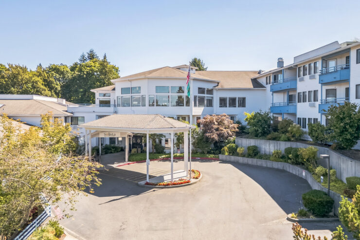 A welcoming entrance surrounded by lush greenery invites residents to a vibrant community.