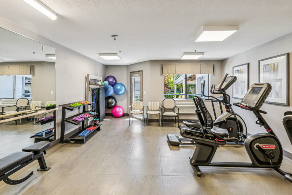 A bright, inviting fitness area equipped with modern exercise machines and colorful fitness balls, fostering community well-being.