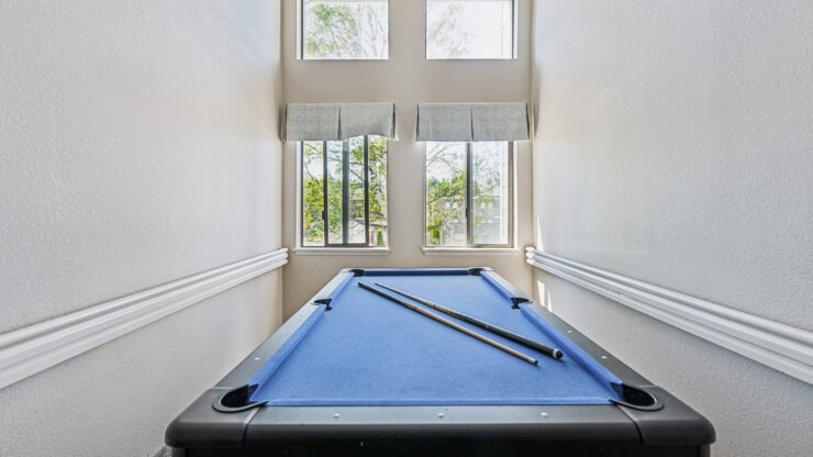 Bright and inviting space featuring a pool table, perfect for friendly gatherings and relaxation.