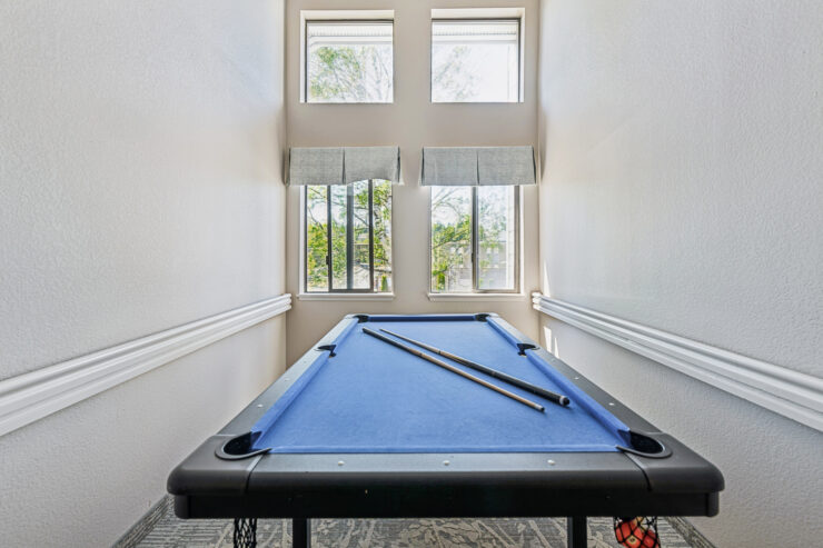 Bright and inviting space featuring a pool table, perfect for friendly gatherings and relaxation.