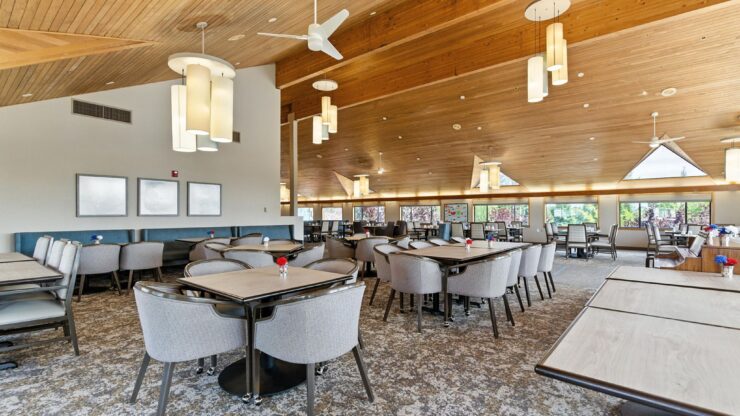 Bright and inviting dining area, featuring comfortable seating and warm natural light, perfect for community gatherings.