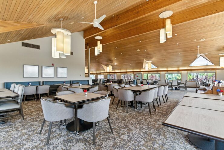 Bright and inviting dining area, featuring comfortable seating and warm natural light, perfect for community gatherings.