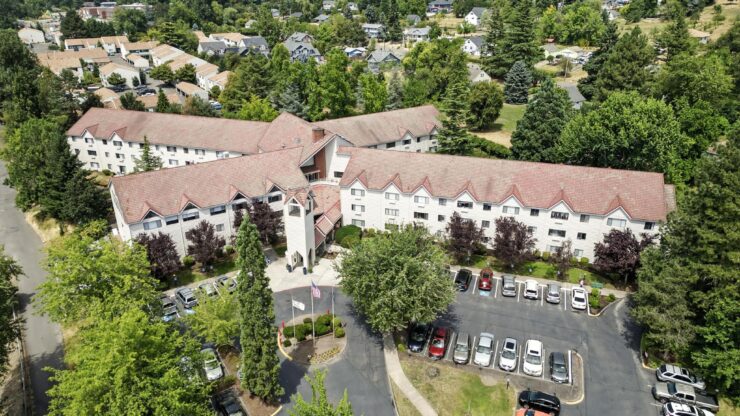 A welcoming retirement community surrounded by greenery, offering comfort and connection for all residents.