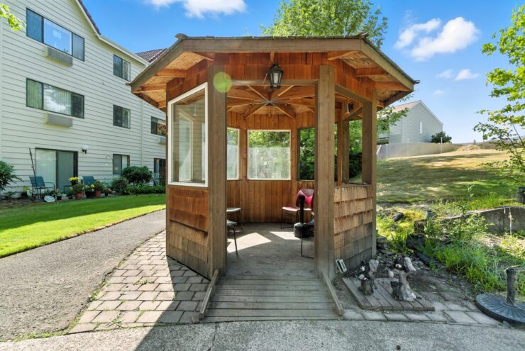 A charming gazebo invites relaxation, surrounded by greenery, fostering community and warmth.