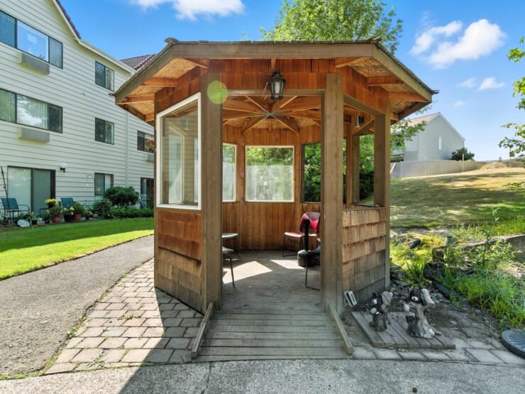 A charming gazebo invites relaxation, surrounded by greenery, fostering community and warmth.