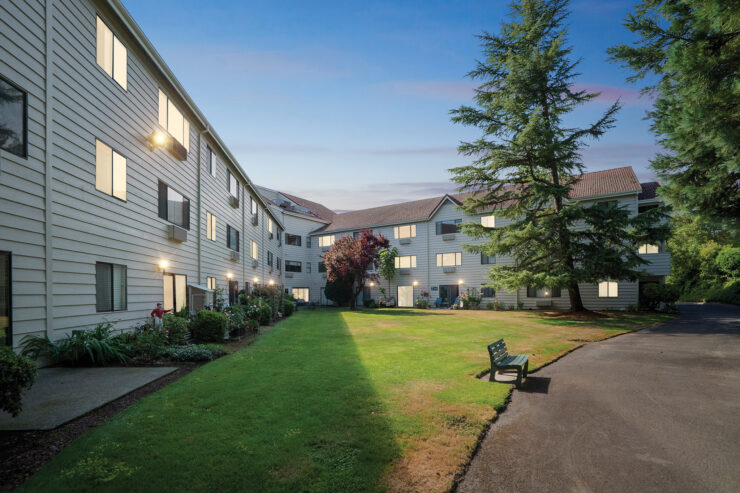 A welcoming outdoor space invites relaxation, surrounded by charming architecture and greenery.