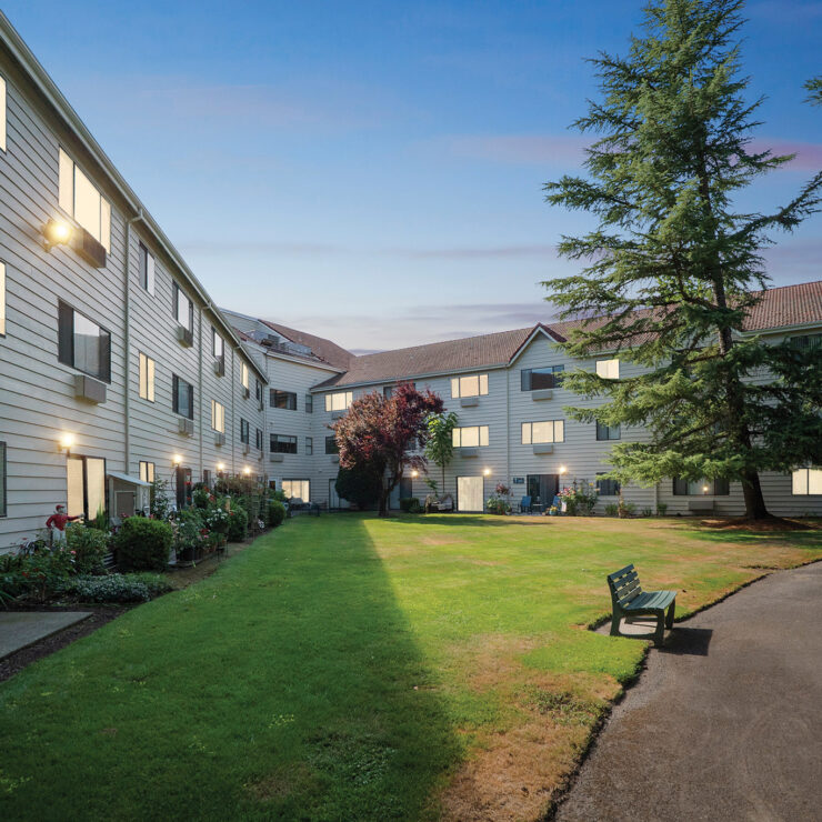 A welcoming outdoor space invites relaxation, surrounded by charming architecture and greenery.