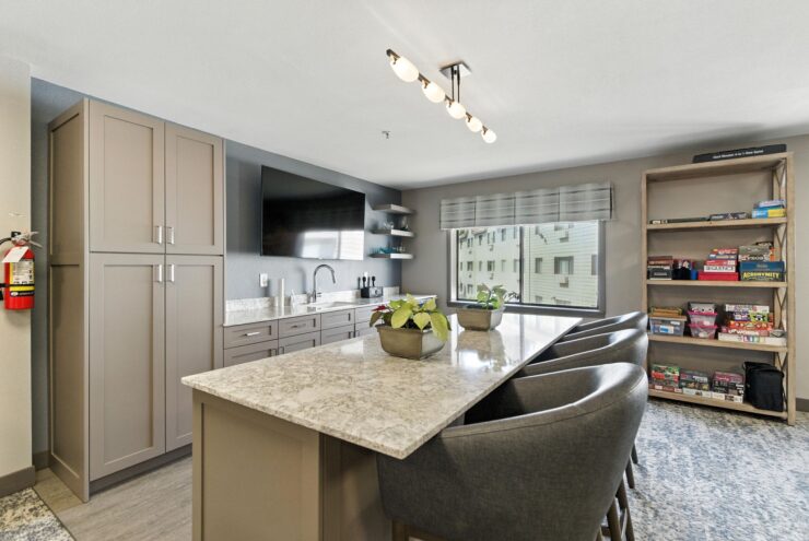A modern kitchen with inviting seating, bright natural light, and a warm, welcoming atmosphere.