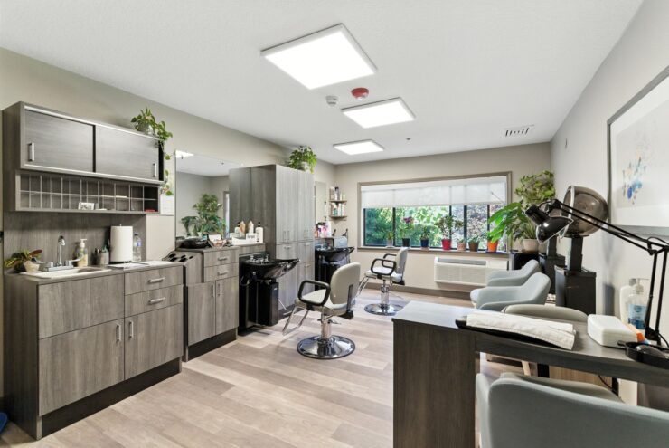 A bright, welcoming salon space designed for relaxation and community connection.