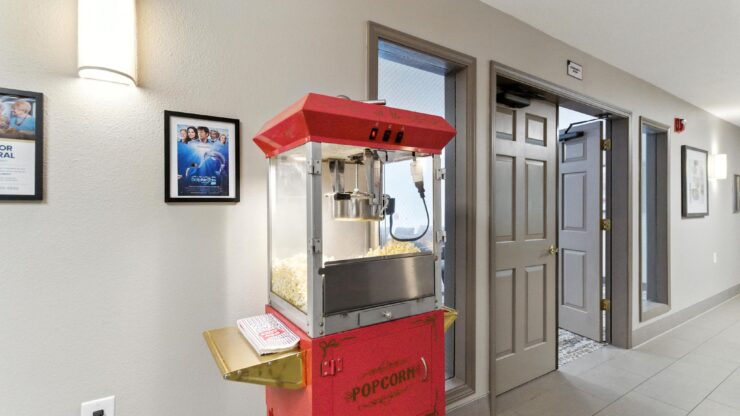 A welcoming hallway features a vintage popcorn machine, inviting residents to enjoy delightful treats together.