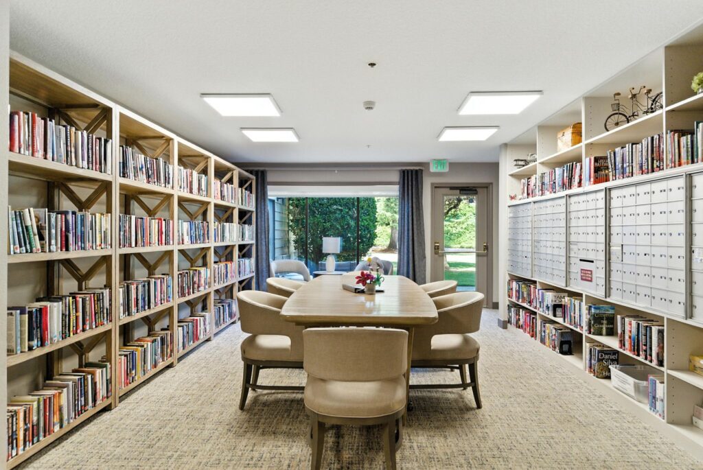 A welcoming reading room with ample natural light, inviting seating, and shelves filled with books, fostering community and relaxation.