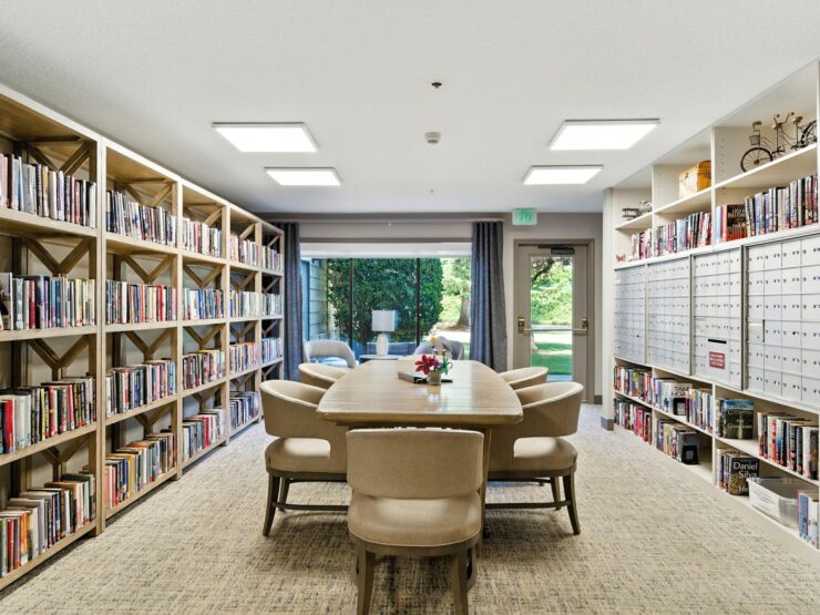 A welcoming reading room with ample natural light, inviting seating, and shelves filled with books, fostering community and relaxation.