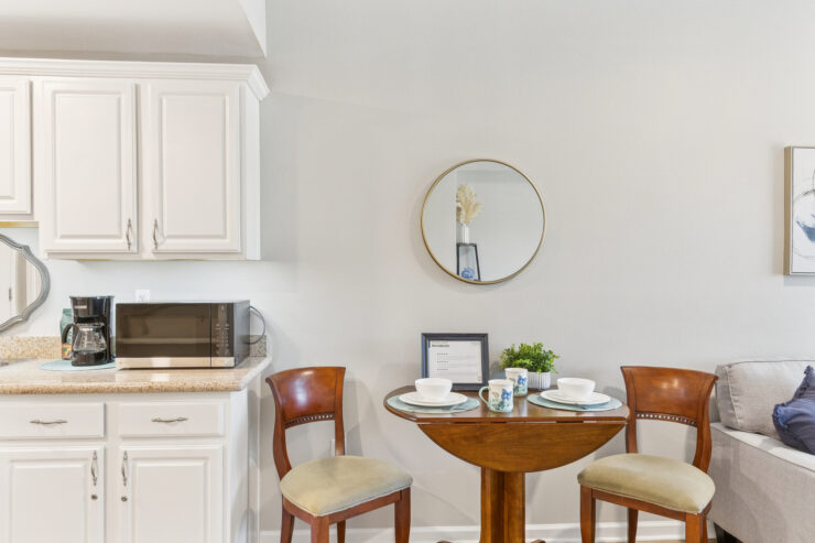A welcoming dining area with a round table set for meals, fostering community and connection.