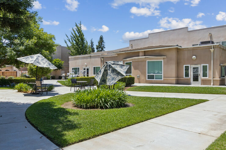 A welcoming outdoor space with lush greenery and inviting seating areas, perfect for community gatherings.