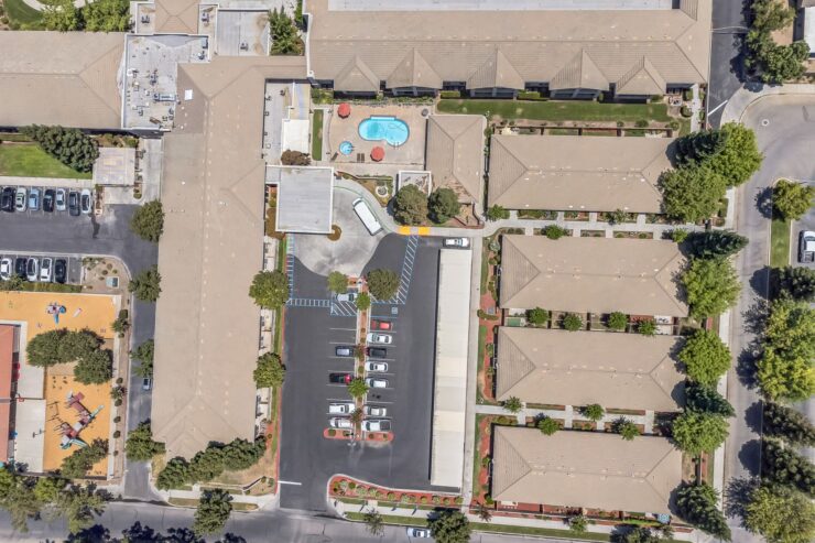 A welcoming community featuring serene outdoor spaces and a central pool area, perfect for relaxation.