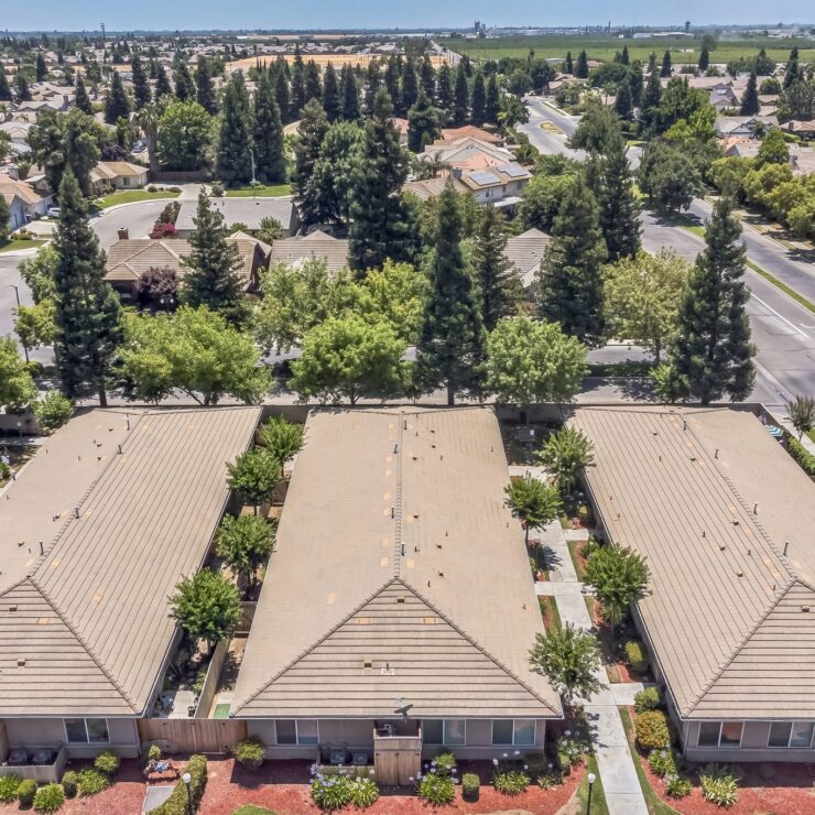 A welcoming community of homes surrounded by lush greenery, fostering comfort and connection.