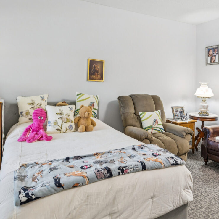 A welcoming bedroom filled with personal touches, inviting relaxation and a sense of community.