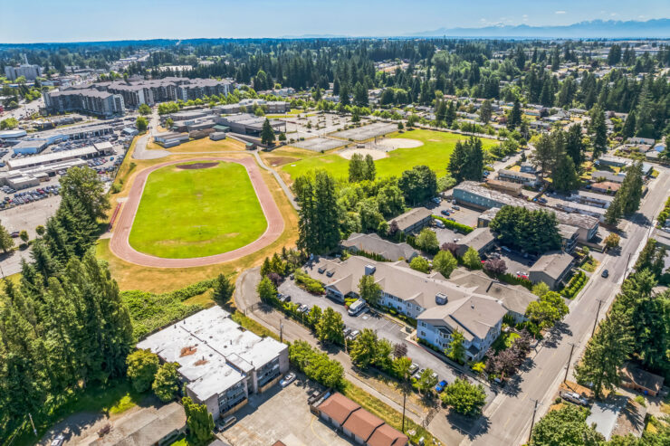 A vibrant community setting with green spaces, inviting homes, and an active atmosphere.