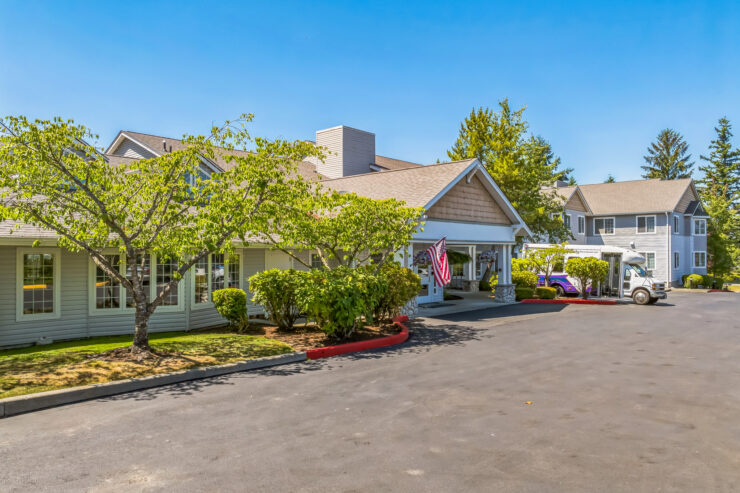 A welcoming retirement community surrounded by lush greenery, offering a serene and friendly atmosphere.