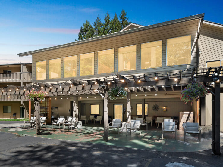 A welcoming outdoor space with comfortable seating, surrounded by nature, perfect for community gatherings.