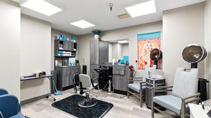 A welcoming salon space, designed for comfort and community, featuring stylish chairs and vibrant decor.