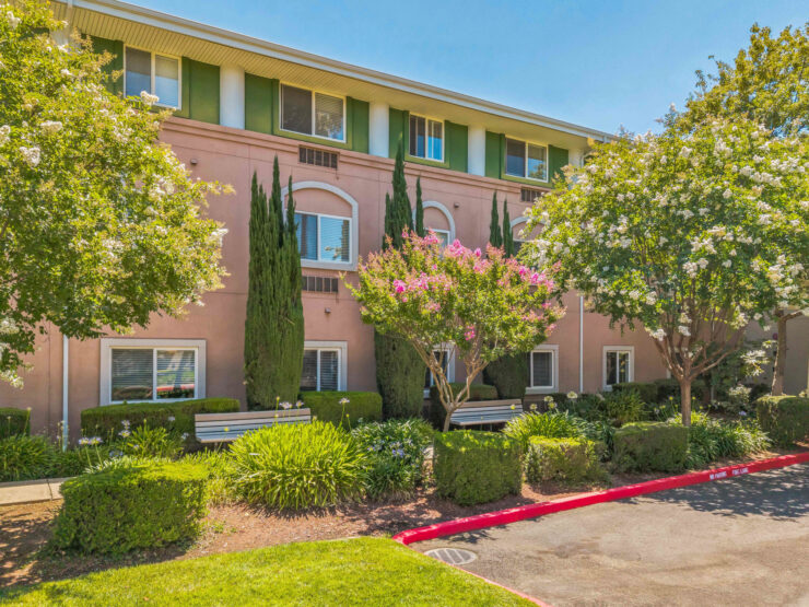 A welcoming retirement community surrounded by vibrant gardens, promoting comfort and connection.