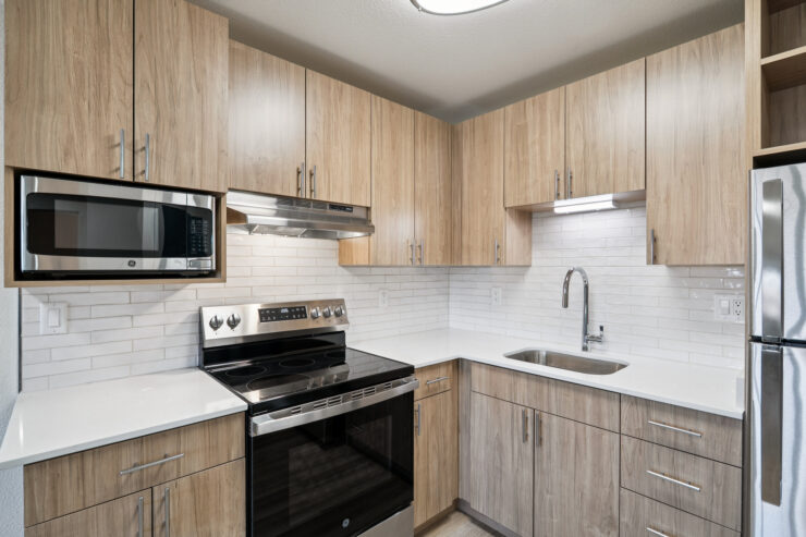 A welcoming kitchen space featuring modern appliances and warm wood cabinetry, perfect for community gatherings.