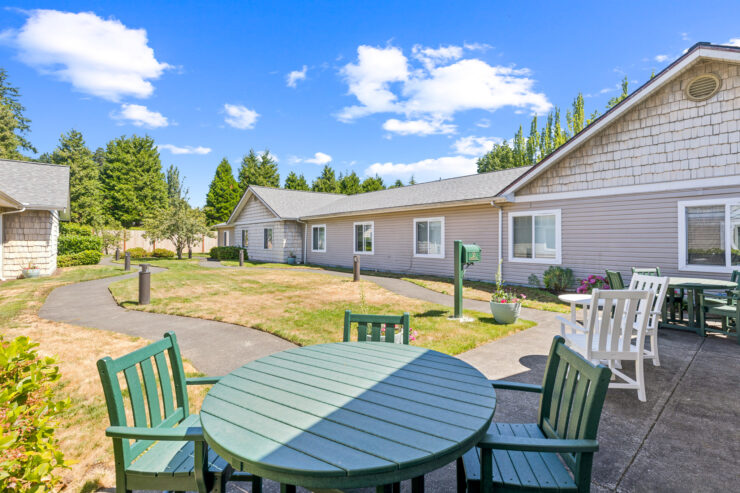 A welcoming outdoor space with green seating invites relaxation and community among residents.