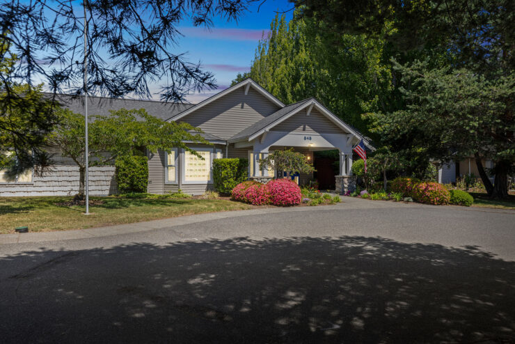 A welcoming entrance surrounded by vibrant greenery, inviting residents to a warm community atmosphere.
