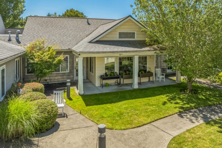 A welcoming retirement community with lush greenery and inviting spaces for relaxation and connection.