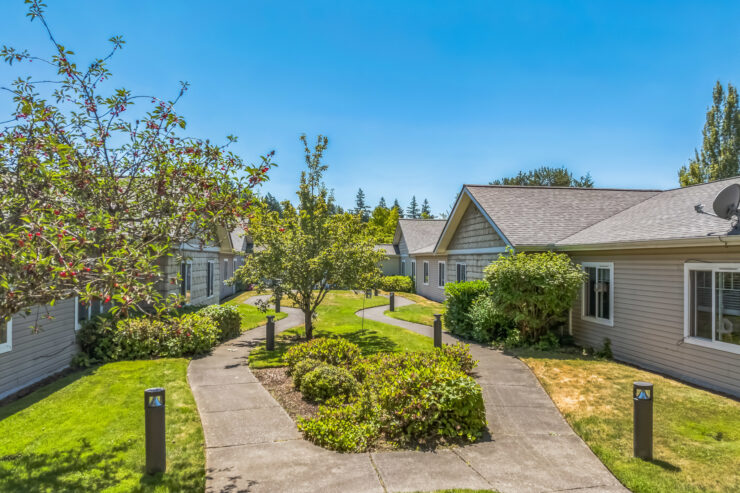 Welcoming pathways meander through beautifully landscaped grounds, inviting a sense of community and tranquility.