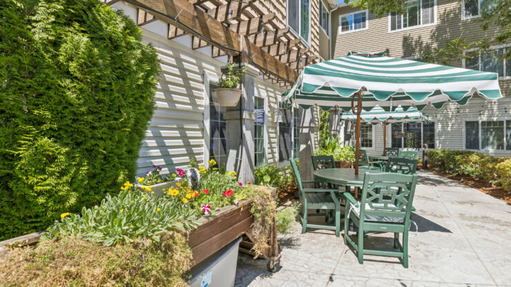 A serene garden space with vibrant flowers and inviting seating fosters community and relaxation.