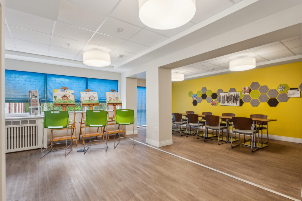 Bright, inviting space with art easels and cheerful decor, fostering creativity and community connection.