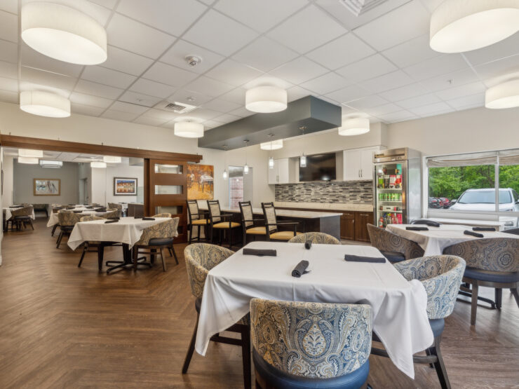 A welcoming dining area with elegant tables, bright lighting, and a warm atmosphere for community gatherings.