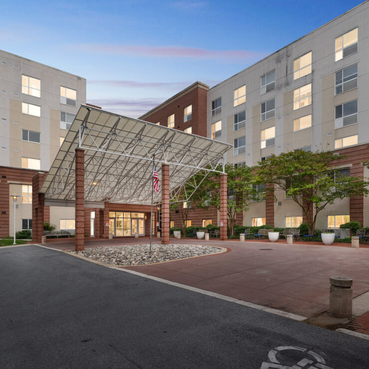A welcoming entrance with lush greenery and a spacious courtyard invites residents to connect and relax.