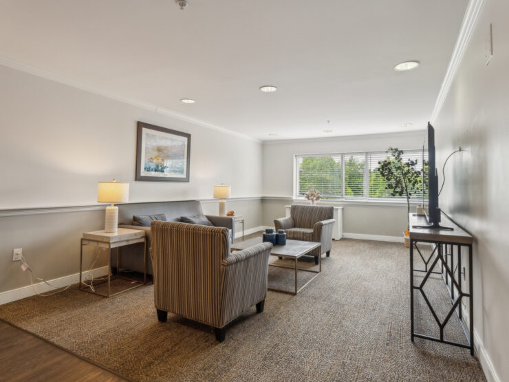 A bright, inviting lounge area with comfortable seating, perfect for community gatherings and relaxation.