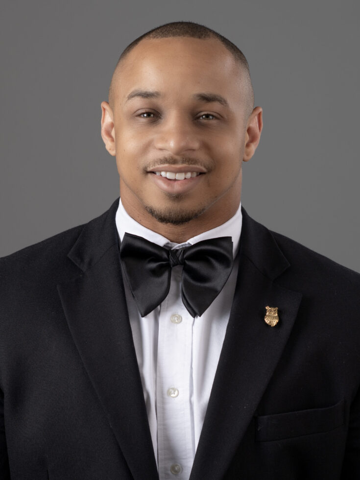 A friendly professional in formal attire exudes warmth and approachability, enhancing community spirit.