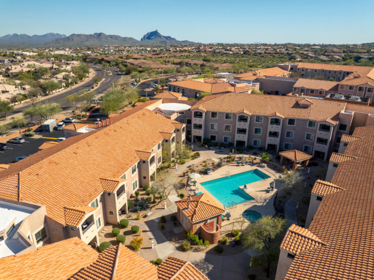 A welcoming community surrounded by scenic views, featuring a serene pool area for relaxation and socializing.
