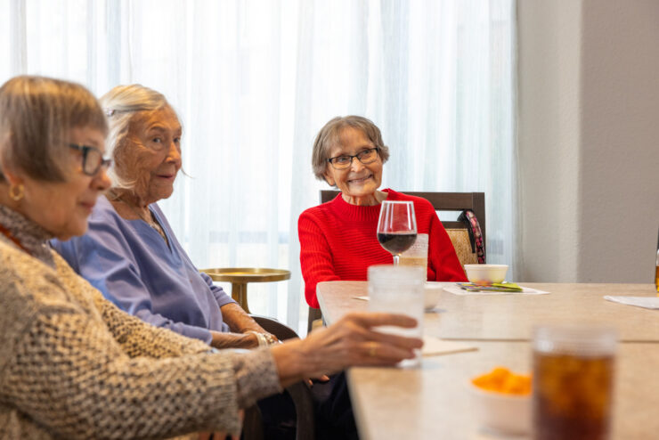 Residents enjoy a lively conversation over refreshments, fostering a warm sense of community.